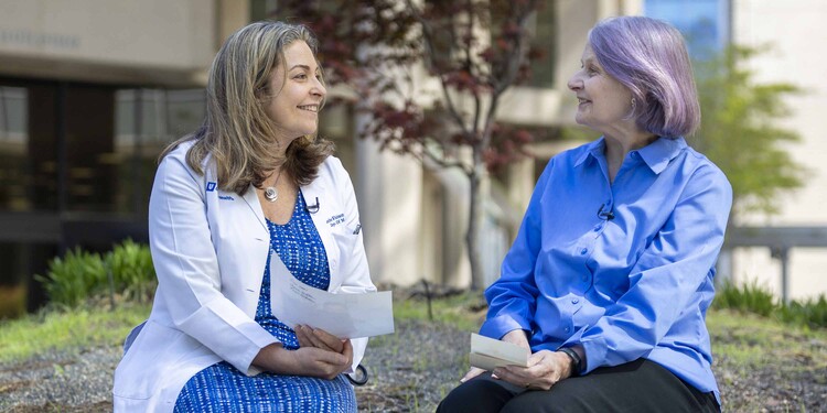 A doctor speaks with a patient outside