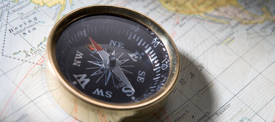 Compass sitting on a map