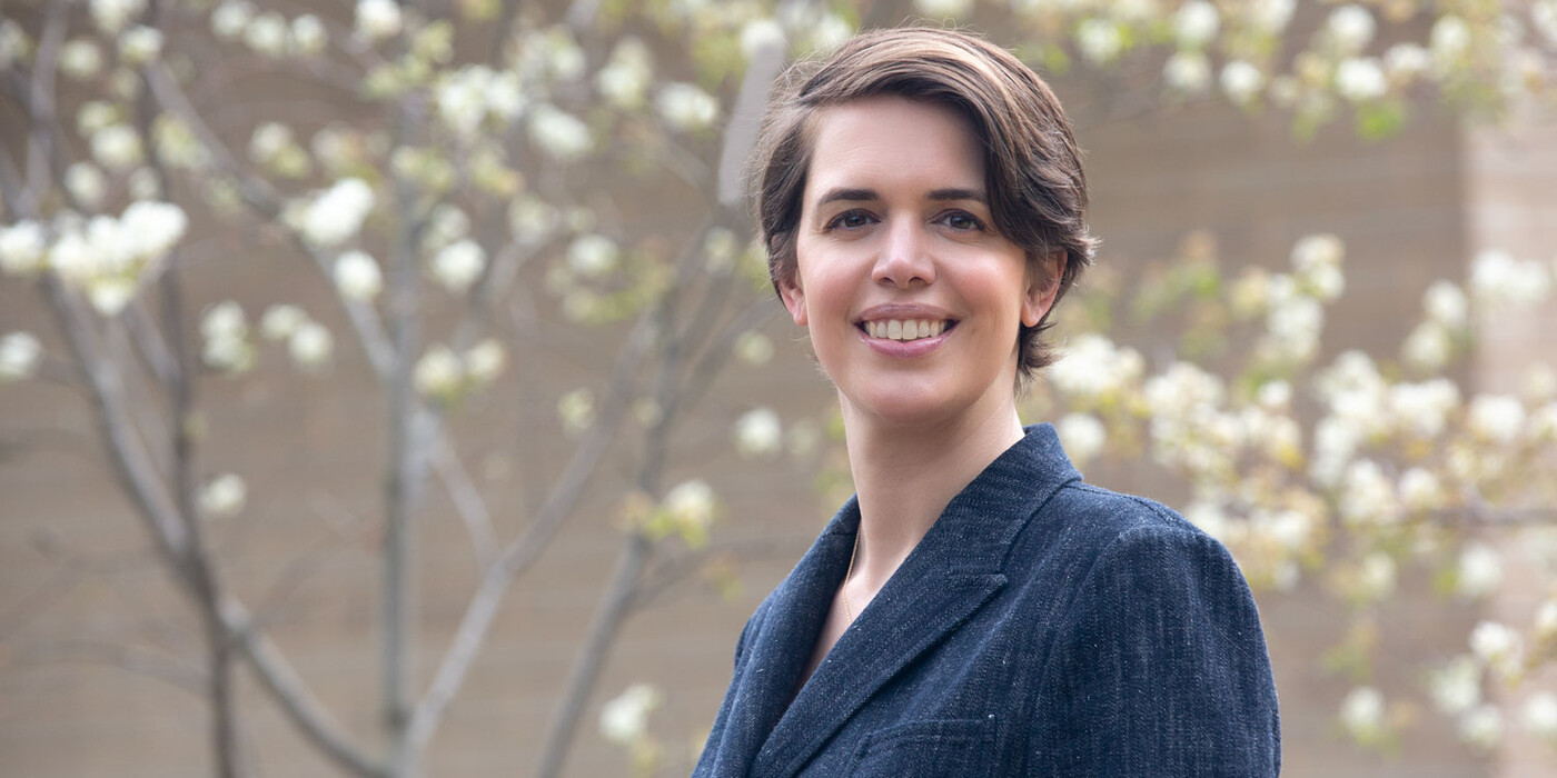 Brooks Bell smiles in front of some flowering trees at her home in Raleigh.