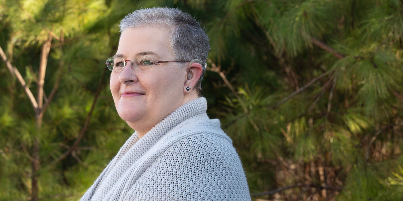 Natalie Williamson of Goldsboro, NC, smiles outside with trees in the background