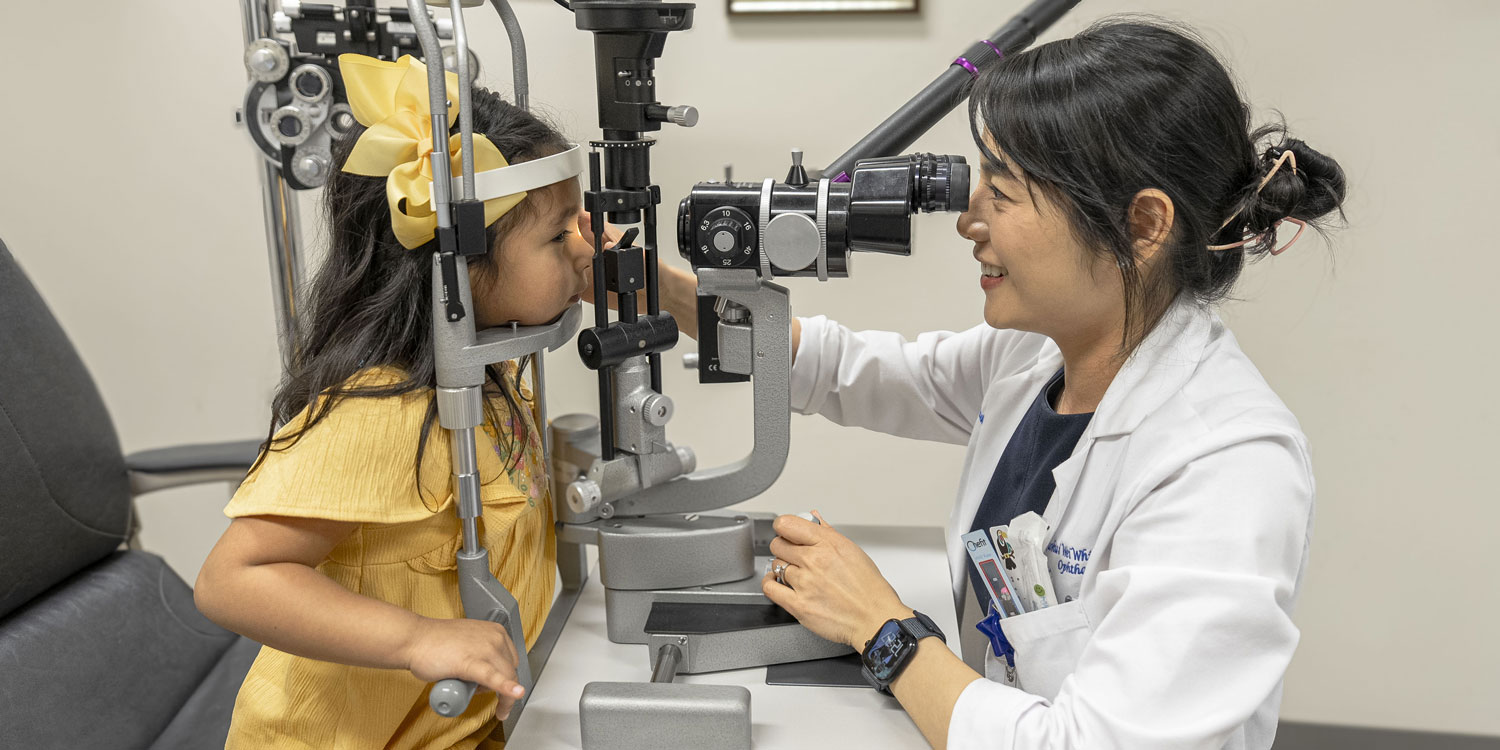 A doctor looks at Emi's eyes