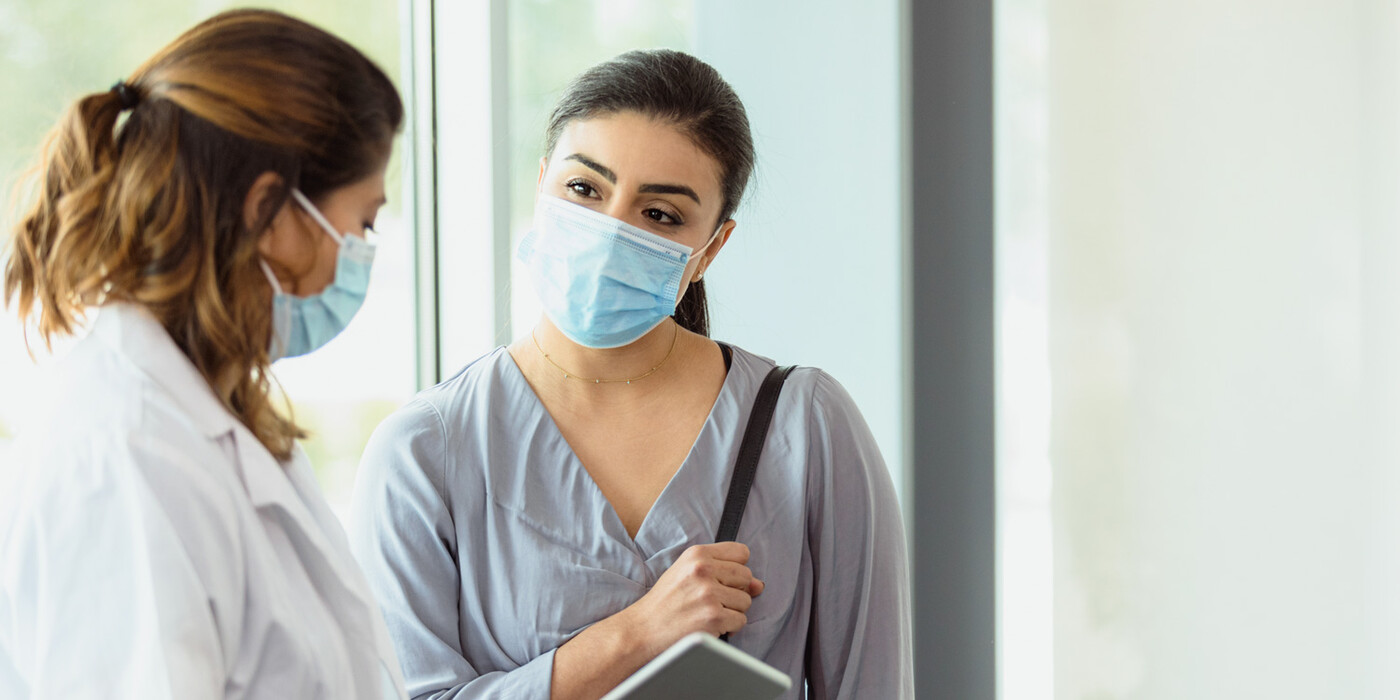 A doctor speaks with a patient