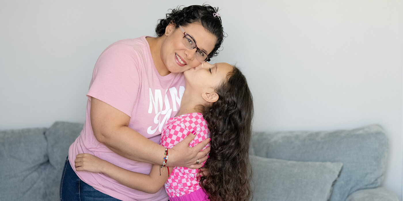 Eliana Vera González smiles as her daughter embraces her at their home in Morrisville, NC.