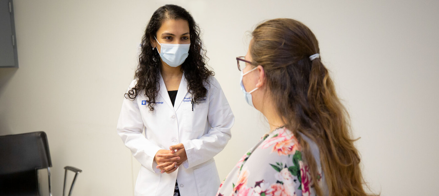 Epileptologist Prachi Parikh, MD, speaks with a patient in clinic.