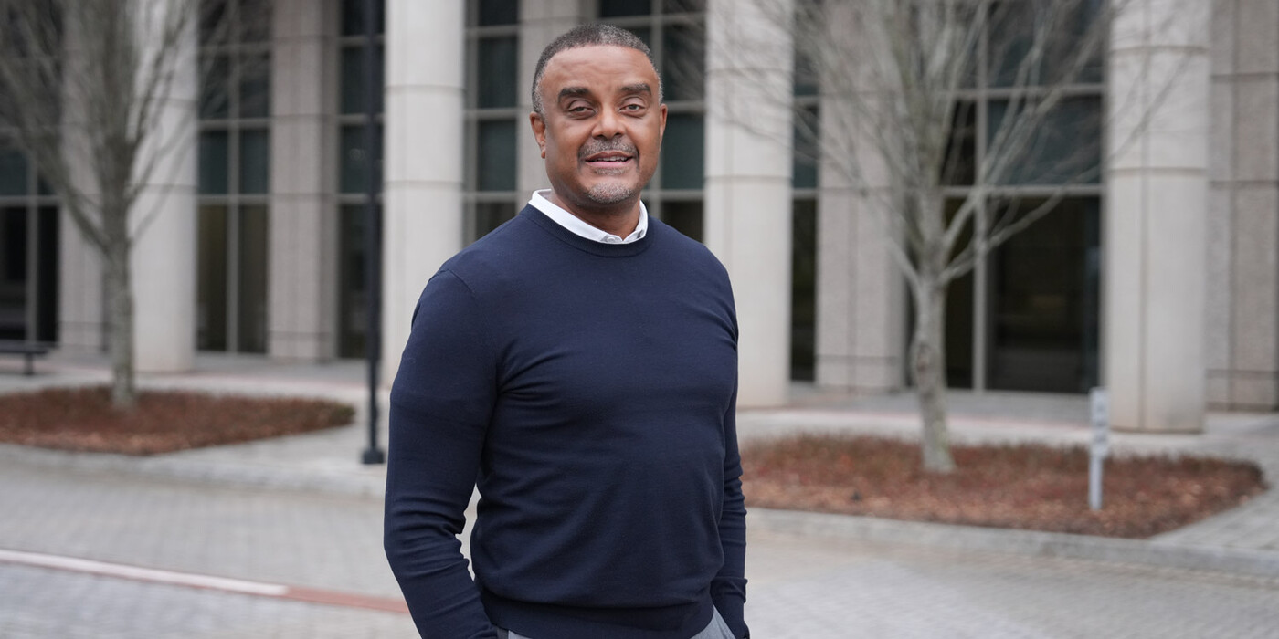 Derek Hill stands outside his Raleigh, NC office. 