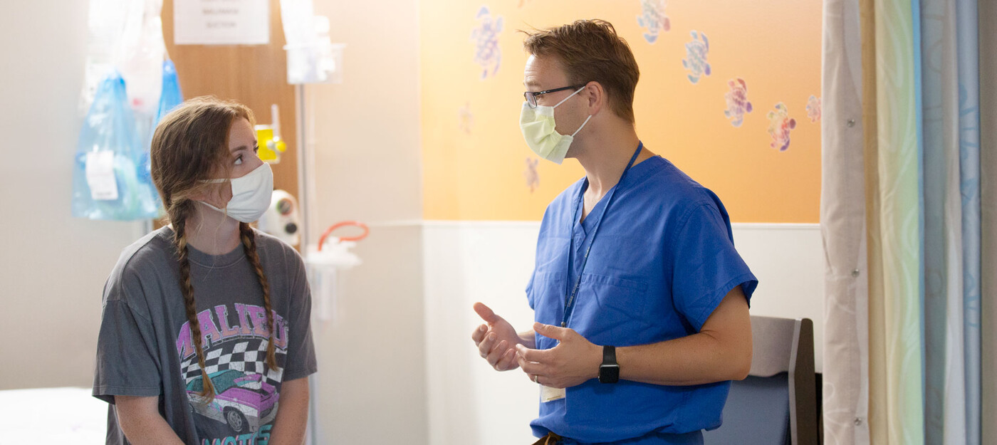 A patient sits and talks to a provider