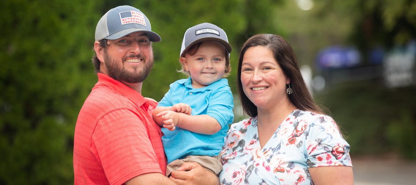 The Hart family smiles outside