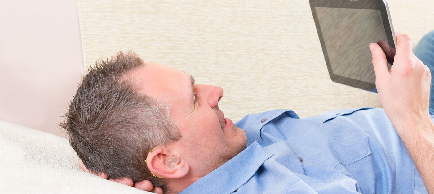 A man looks at a tablet