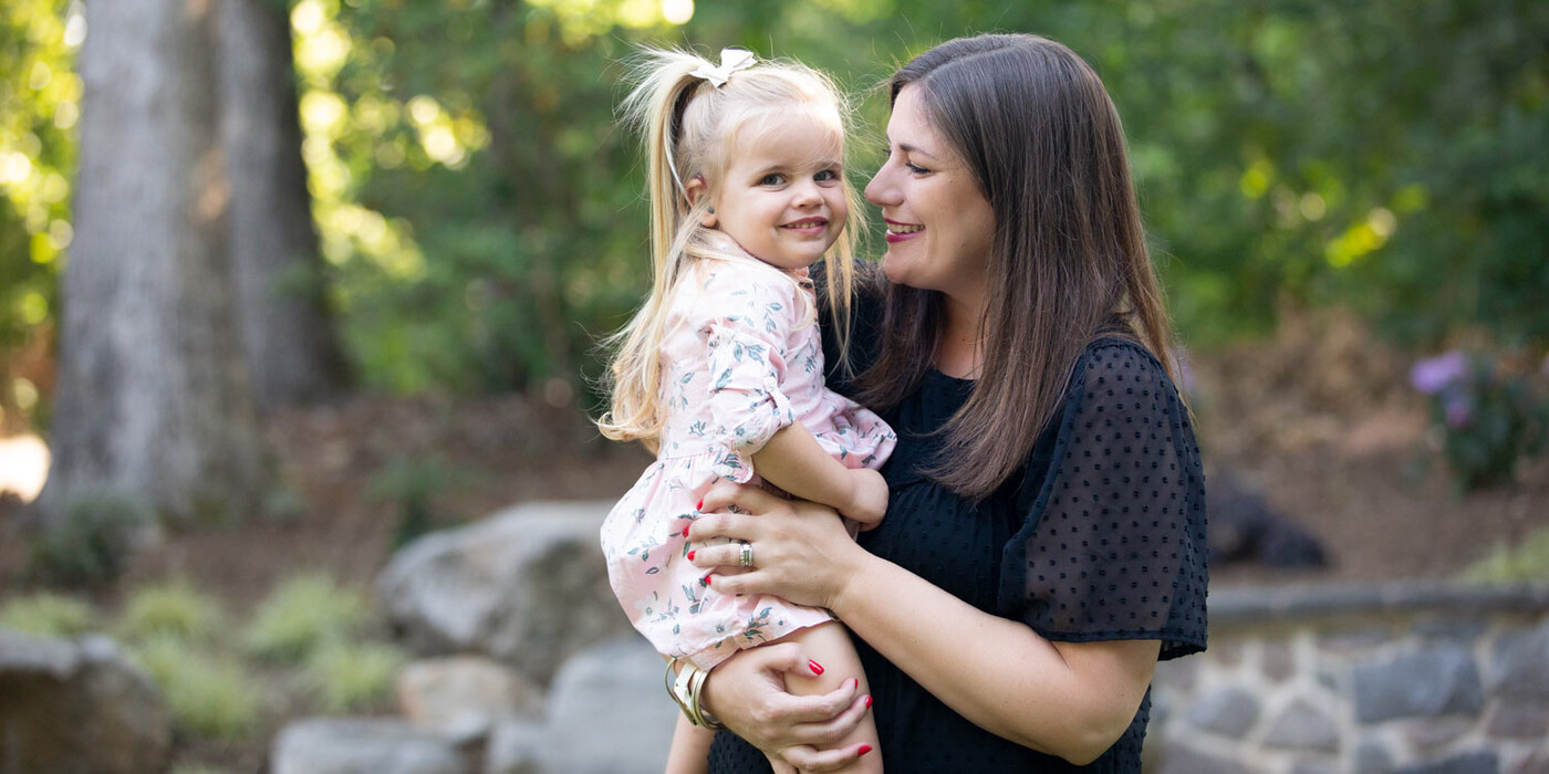 Holly VanHorn holds her daughter Nessa outside the family's home in Raleigh, NC.