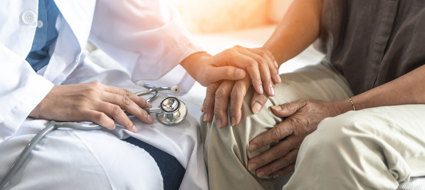 a provider holds a patient's hand