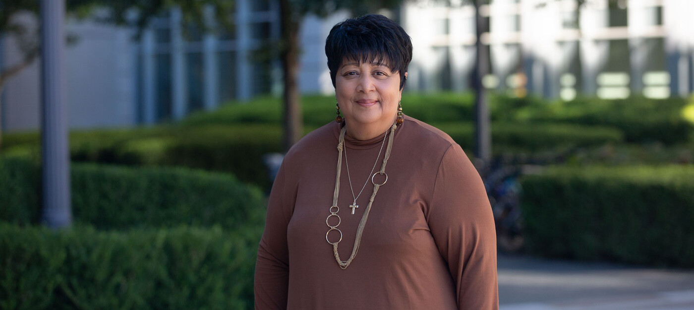 Duke breast cancer patient stands in front of building