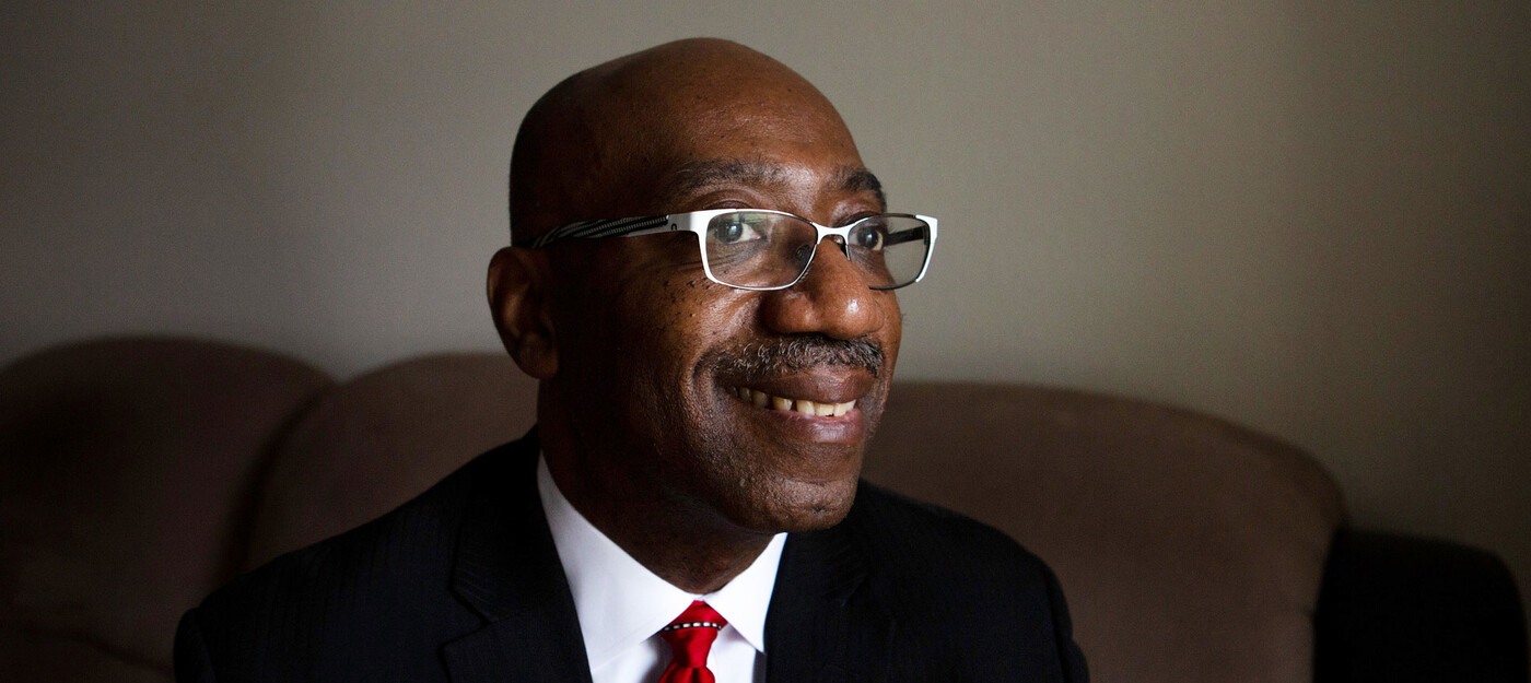 A man smiles in his living room