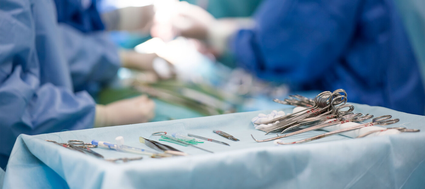 A surgical tray with surgeons working in the background