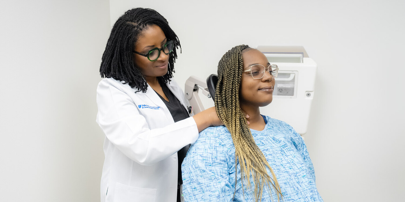 A doctor feels a patient's neck
