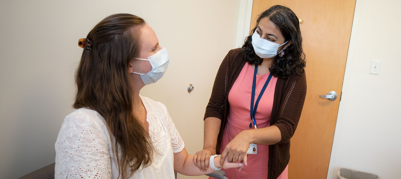 A provider tests a patient's arm and wrist movement
