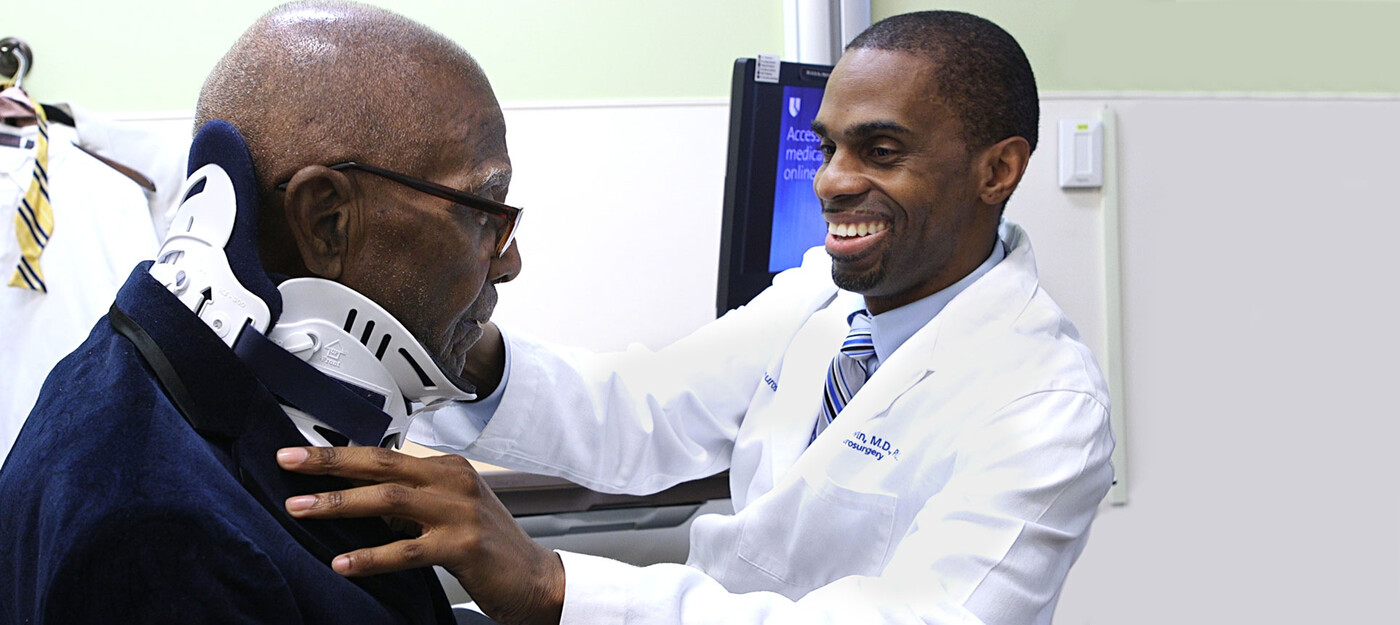 A provider removes a patient's neck brace