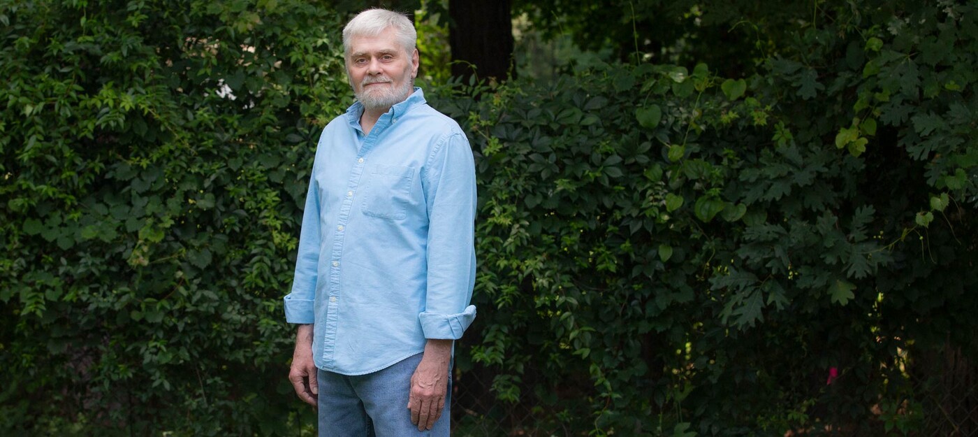 James Moharter stands in front of trees