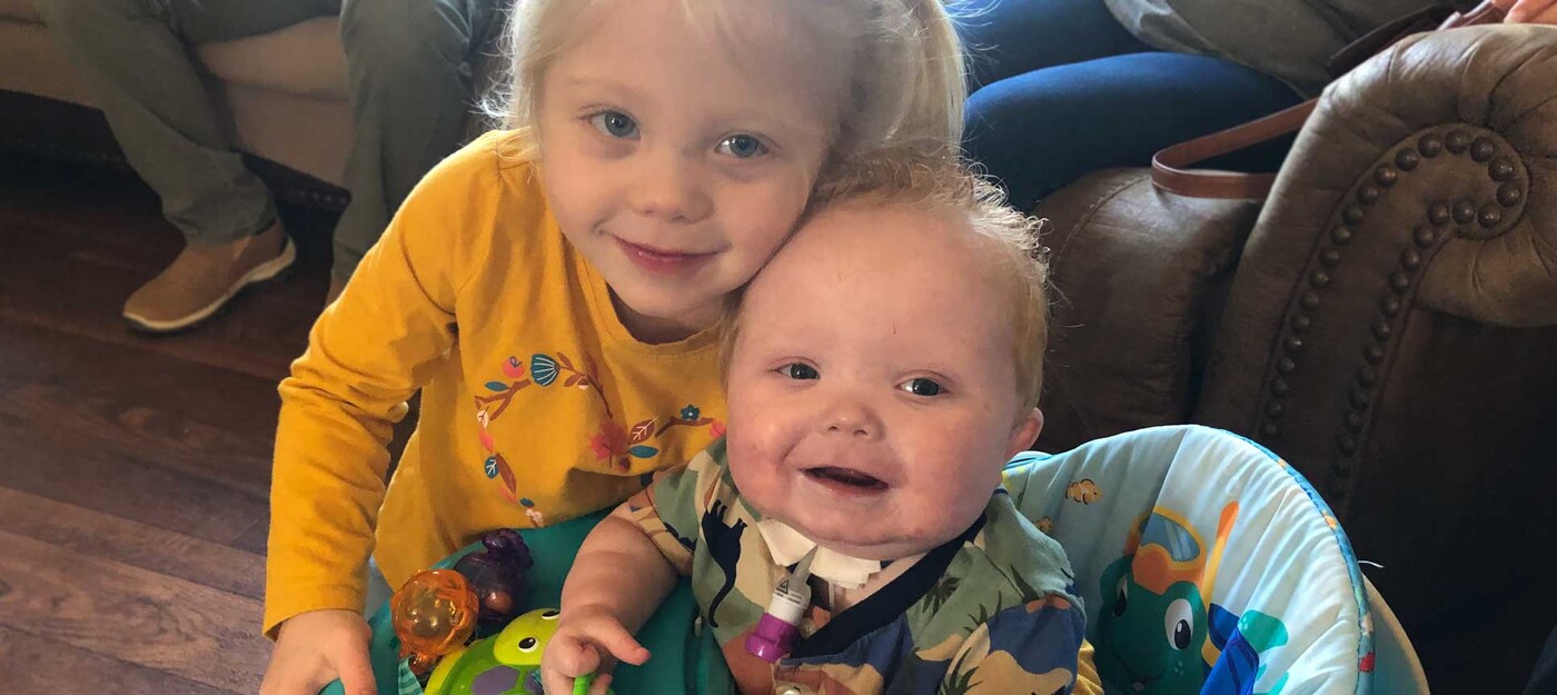 Easton Sinnamon smiles alongside his sister, Ivy, at his one-year birthday celebration. Credit: Sinnamon Family.