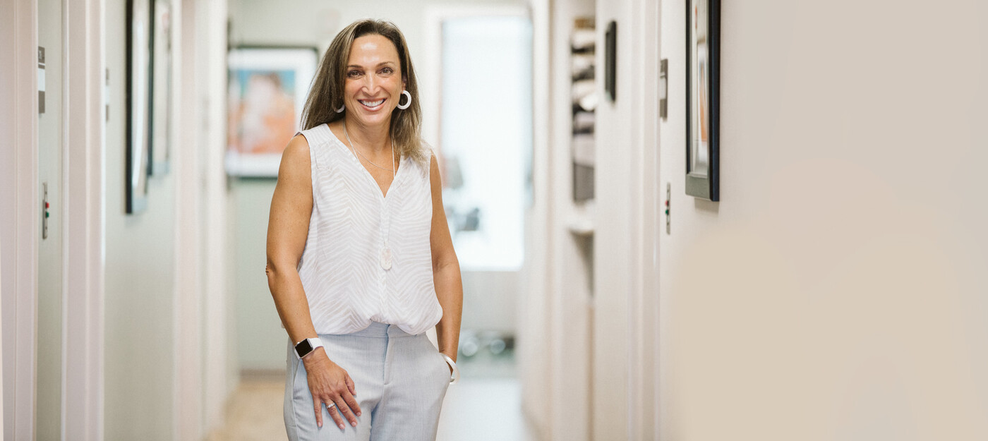 Dr. Clifford smiles inside the clinic hallway