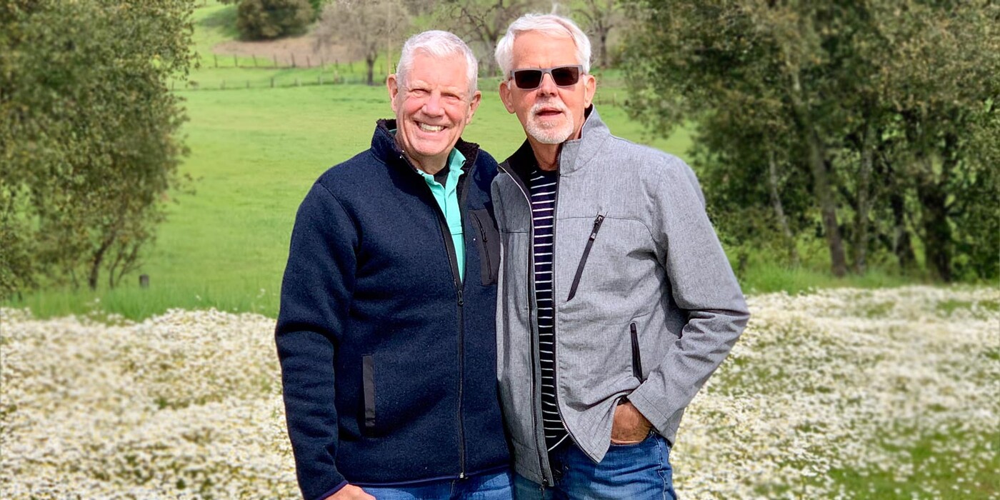 George Getz, right, and his husband stand in a field of flowers in Sonoma, California. 