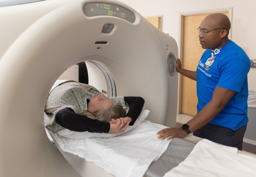 A technician runs a scan on a patient