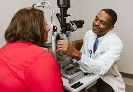 A provider examines a patient's eyes