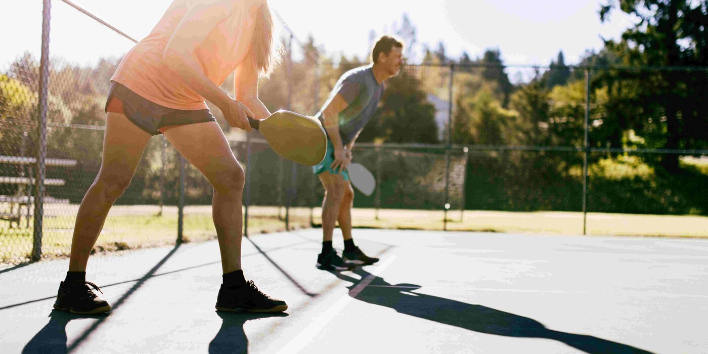 Two people playing pickleball