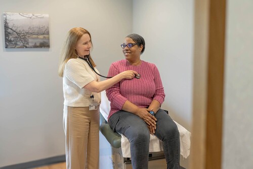 A doctor listens to a patient's heart