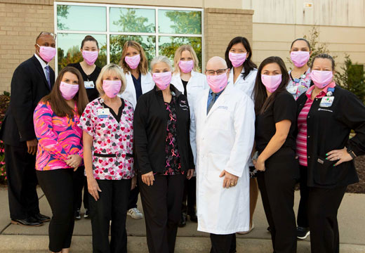 Providers wear pink masks for breast cancer awareness