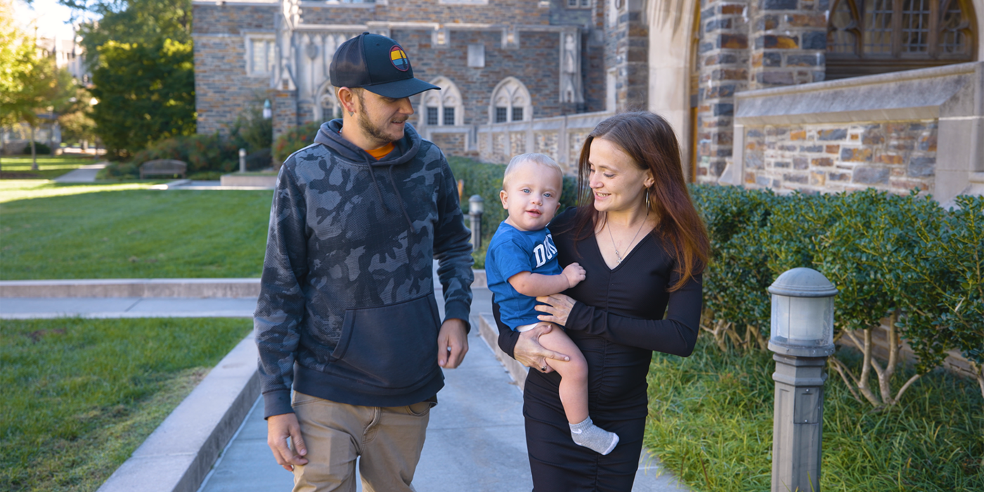 Brianna Ellington walking with her partner and son